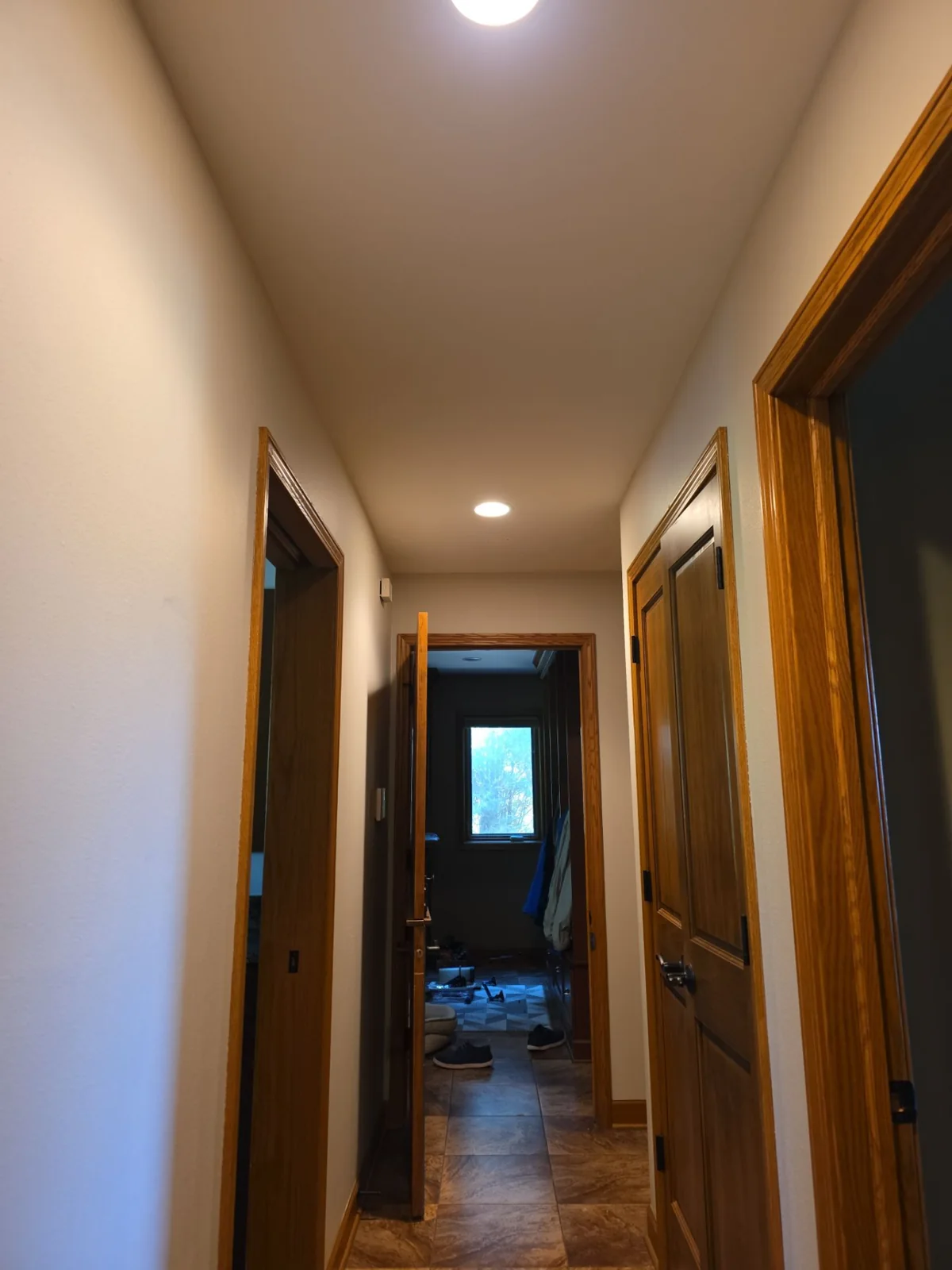 September 28 project view: connected hallway walls, ceiling and natural wood door trim.