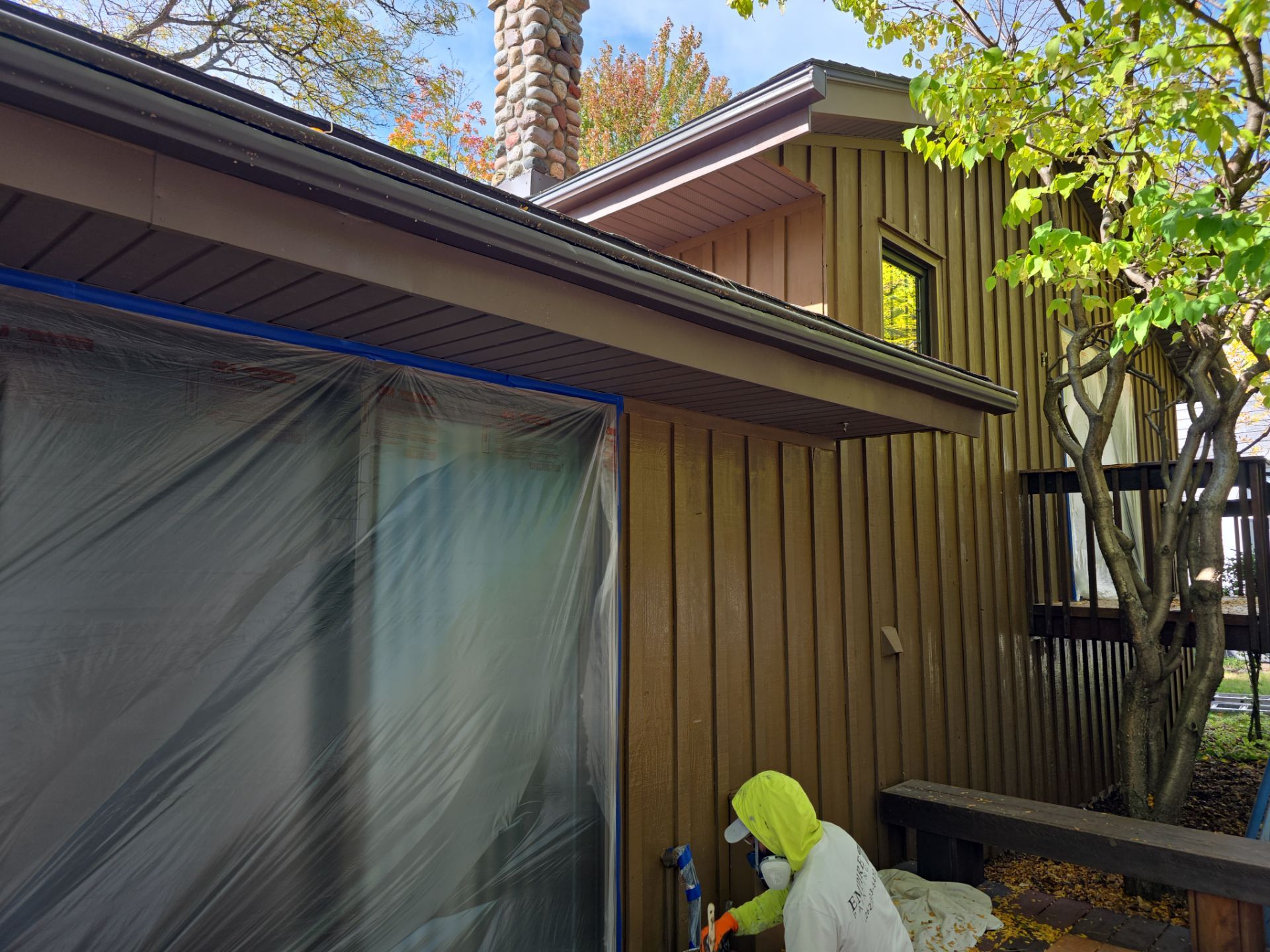 Empire crew working beside a protected window during exterior painting