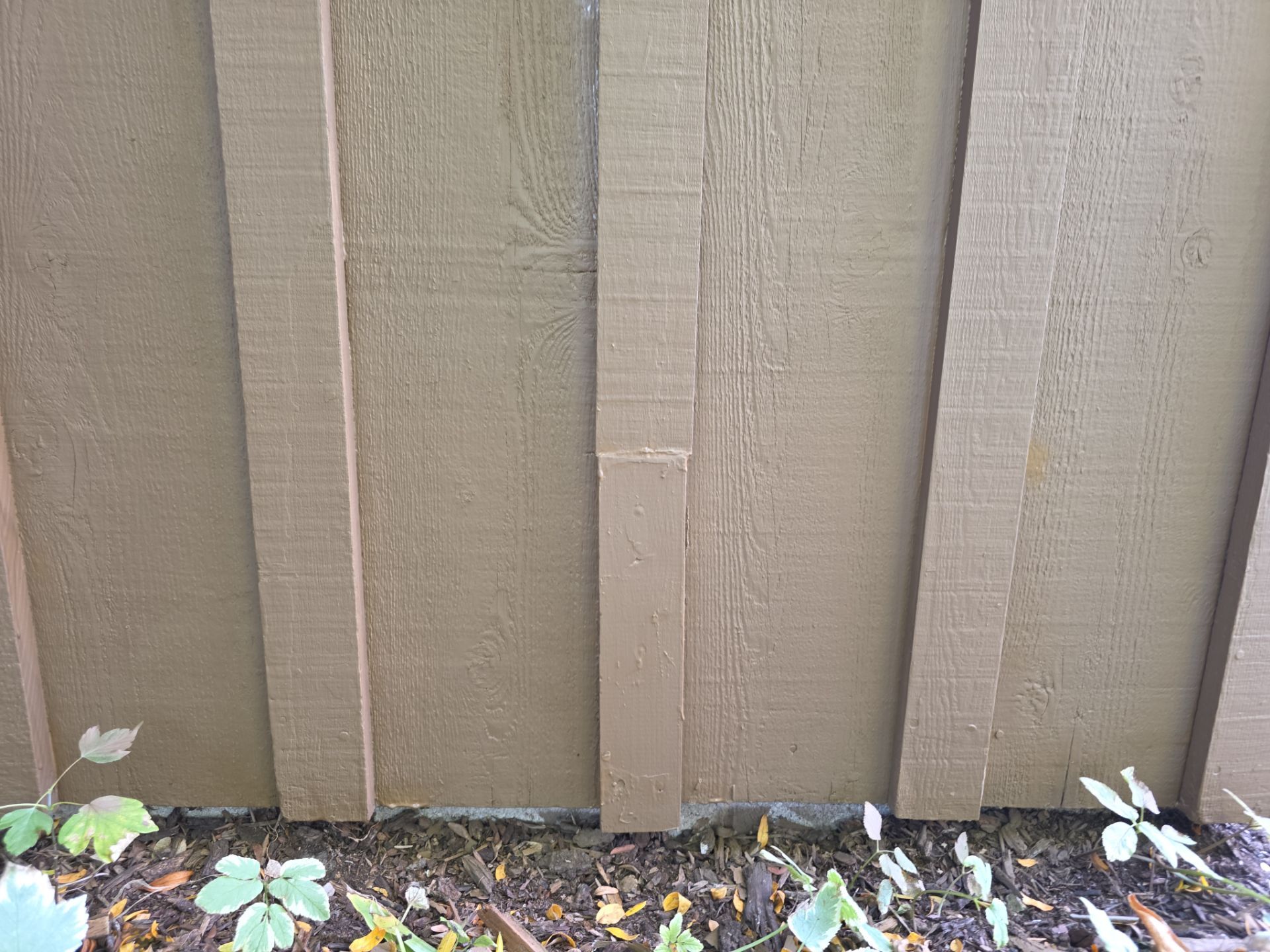 Weathered coating on vertical wood siding before preparation